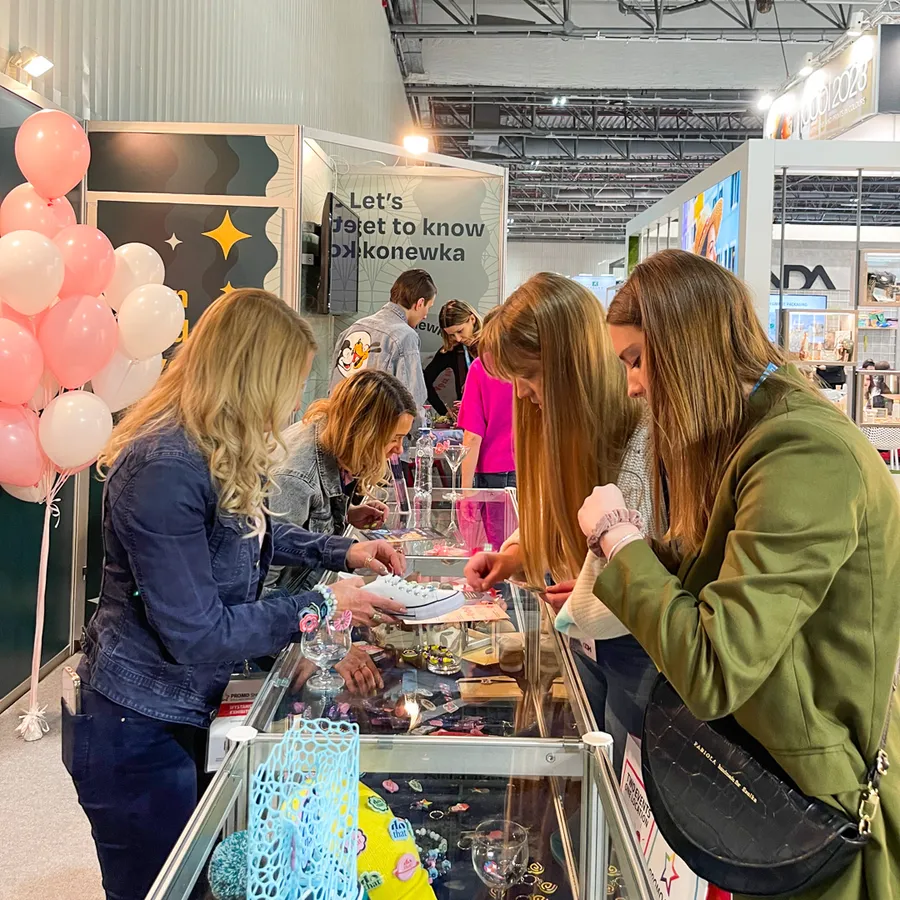 Visitors looking at gadgets in the dothat stand’s display case