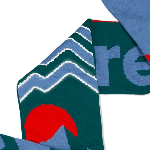 Green and light blue scarf with a reflective zigzag pattern knitted into the fabric